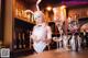 A woman in a bunny costume standing behind a bar.