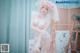 A woman in a white lingerie posing for a picture.